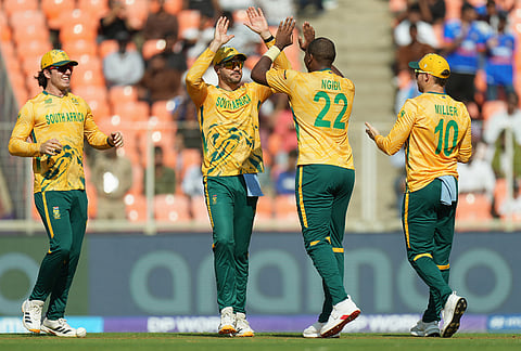 South Africa's Lungi Ngidi, second right, celebrates with captain Aiden Markram the wicket of West Indies' Rovman Powell during the T20 World Cup cricket match between South Africa and West Indies in Ahmedabad.