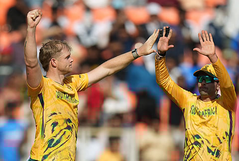 South Africa's Corbin Bosch, left, celebrates with teammate Keshav Maharaj the wicket of West Indies' Matthew Forde during the T20 World Cup cricket match between South Africa and West Indies in Ahmedabad.