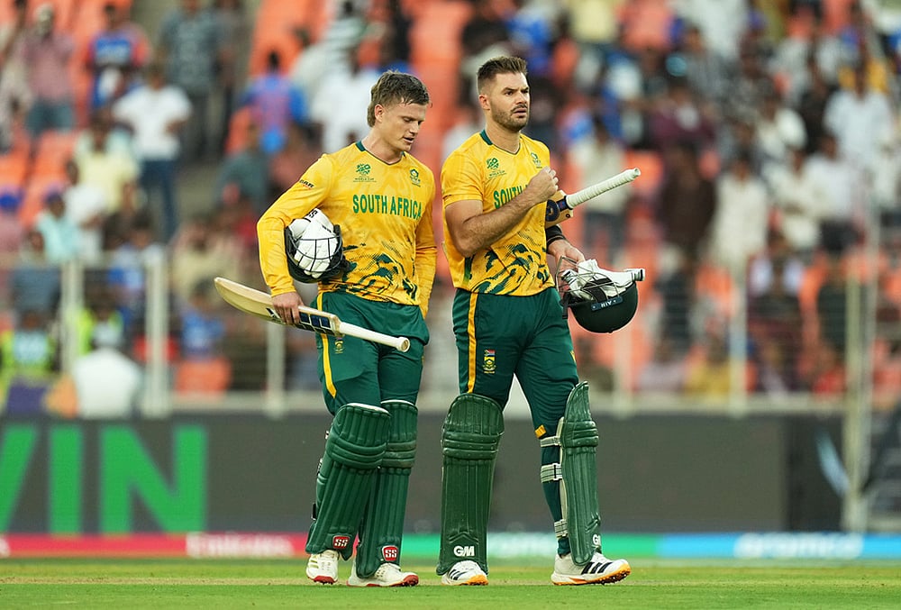 | Photo: AP/Ajit Solanki : South Africa's captain Aiden Markram, right, and batting partner Ryan Rickelton leave the ground after winning their T20 World Cup cricket match against West Indies in Ahmedabad.