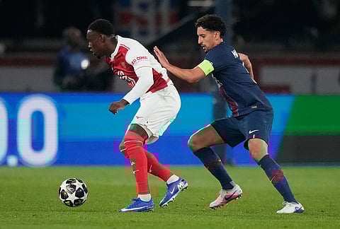 PSG's Marquinhos guards Monaco's Folarin Balogun during a Champions League second leg playoff soccer match between Paris Saint-Germain and Monaco in Paris.