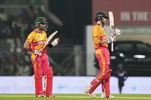 Zimbabwe's Brian Bennett, right, celebrates his fifty runs during the T20 World Cup cricket match between India and Zimbabwe in Chennai, India.
