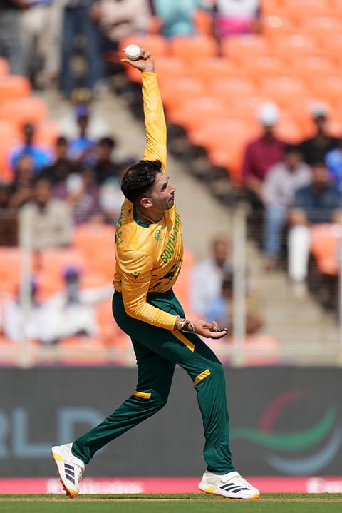 South Africa's Keshav Maharaj bowls a delivery during the T20 World Cup cricket match between South Africa and West Indies in Ahmedabad.