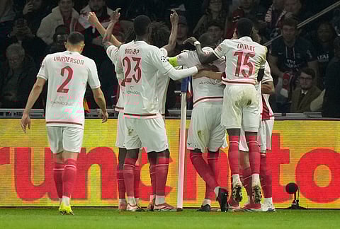 Monaco players celebrate after a goal during a Champions League second leg playoff soccer match between Paris Saint-Germain and Monaco in Paris.