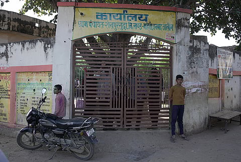 Curious citizens of Shekhpur lines up to take a look from the gate of the Panchayat office. Their curious gaze fixated 
