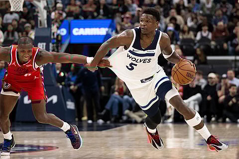 Minnesota Timberwolves guard Anthony Edwards, right, drives to the basket past Los Angeles Clippers guard Kris Dunn during the second half of an NBA basketball game in Inglewood, Calif.
