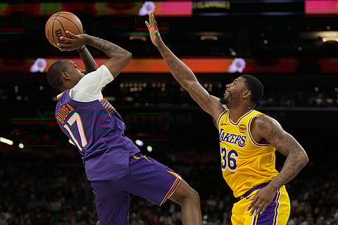 Phoenix Suns guard Jamaree Bouyea shoots over Los Angeles Lakers guard Marcus Smart (36) during the second half of an NBA basketball game in Phoenix.