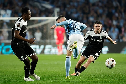 Celta's Iago Aspas, center, vies for the ball with PAOK's Marcos Alonso, right, during the second leg of the Europa League playoff soccer match between Celta Vigo and PAOK in Vigo, Spain.