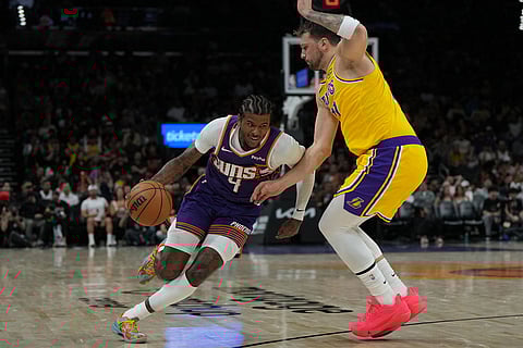 Phoenix Suns guard Jalen Green (4) drives on Los Angeles Lakers guard Luka Doncic during the second half of an NBA basketball game in Phoenix.