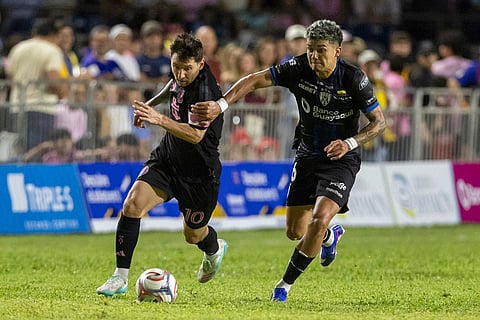 Inter Miami's Lionel Messi competes for the ball with Ronald Briones of Ecuador's Independiente del Valle during an international friendly soccer match in Bayamon, Puerto Rico.