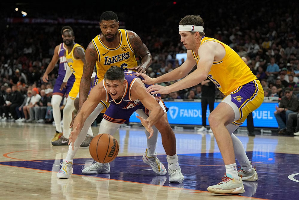 | Photo: AP/Rick Scuteri : Phoenix Suns guard Grayson Allen grabs the loose ball in between Los Angeles Lakers guard Marcus Smart, left, and guard Austin Reaves during the second half of an NBA basketball game in Phoenix.