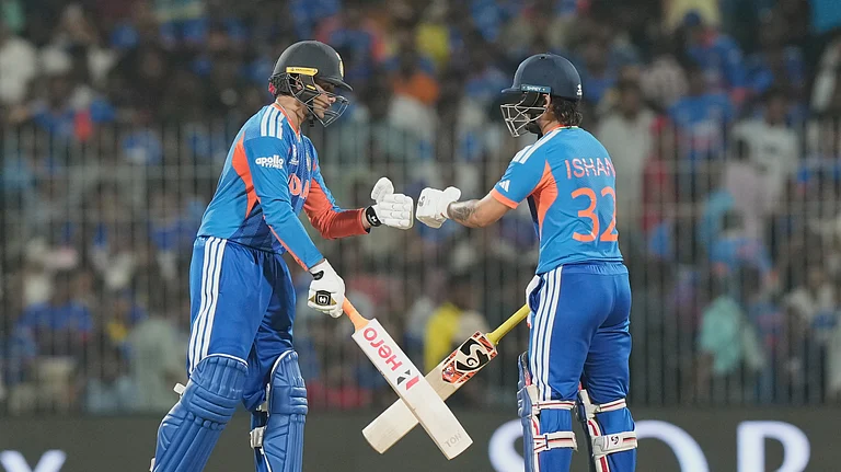 India's Abhishek Sharma, left fist bumps his batting partner Ishan Kishan during the T20 World Cup cricket match between India and Zimbabwe in Chennai, India, Thursday, Feb. 26, 2026. - (AP Photo/Mahesh Kumar A.)