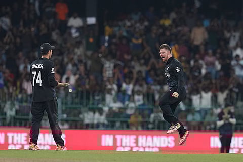 New Zealand's Glenn Phillips celebrates the wicket of England's captain Harry Brook, as captain Mitchel Santner, left, looks on during the T20 World Cup cricket match between England and New Zealand in Colombo, Sri Lanka.