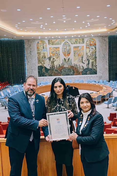 Nidhi Kar receiving an award