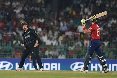 New Zealand's Lockie Ferguson, left, celebrates the wicket of England's Jos Buttler, right, walks on during the T20 World Cup cricket match between England and New Zealand in Colombo, Sri Lanka.