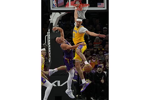 Los Angeles Lakers center Jaxson Hayes (11) fouls Phoenix Suns guard Grayson Allen during the first half of an NBA basketball game in Phoenix.