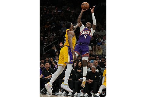 Phoenix Suns guard Jalen Green (4) shoots over Los Angeles Lakers guard Marcus Smart during the second half of an NBA basketball game in Phoenix.