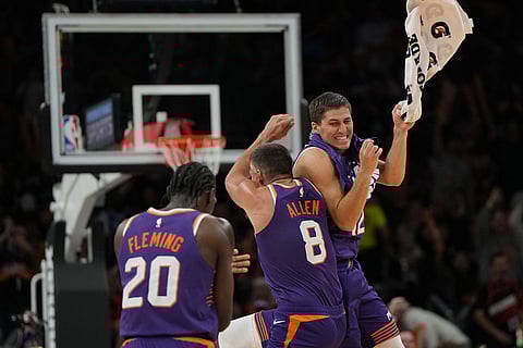 Phoenix Suns forward Rasheer Fleming, guard Grayson Allen (8), and guard Collin Gillespie celebrate against the Los Angeles Lakers during the second half of an NBA basketball game in Phoenix.