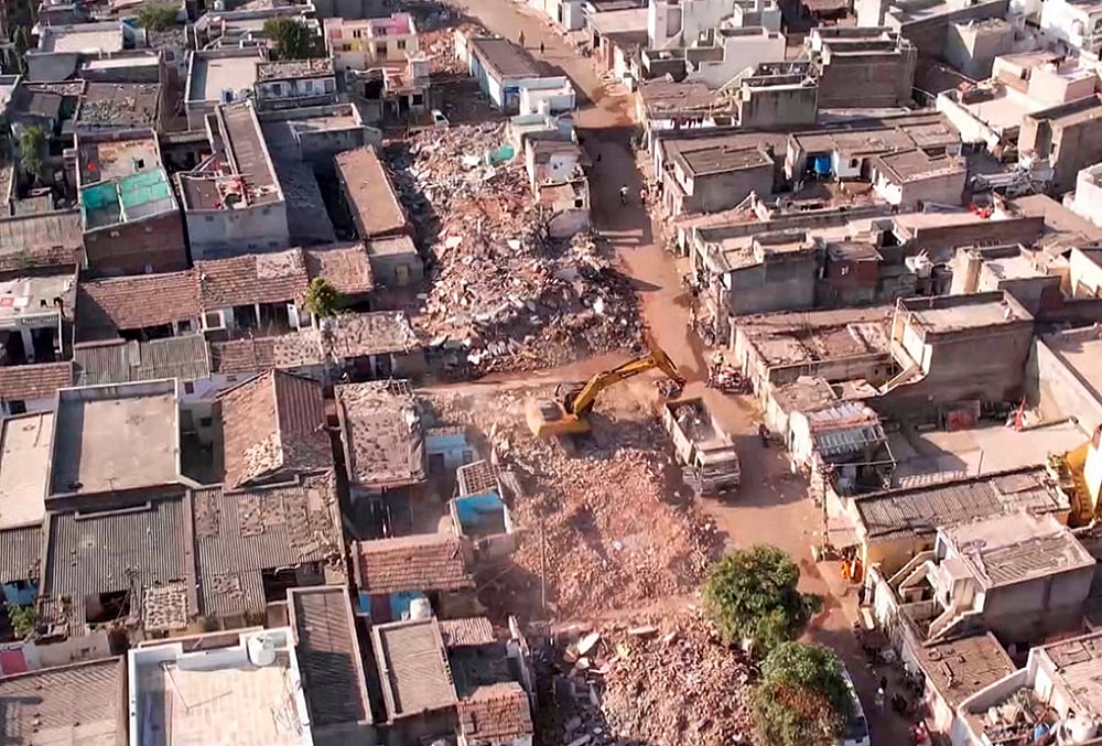 An aerial view shows the aftermath of a demolition drive to clear illegal houses along the Aji river banks and TP Road in Jangleshwar, Rajkot, Gujarat. - | Photo: PTI