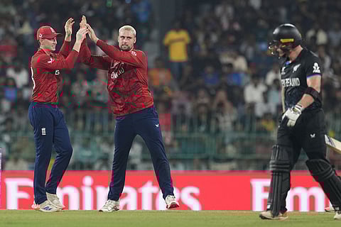 England's Will Jacks, right, celebrates with captain Harry Brook the wicket of New Zealand's Glenn Phillips, right, walks during the T20 World Cup cricket match between England and New Zealand in Colombo, Sri Lanka.