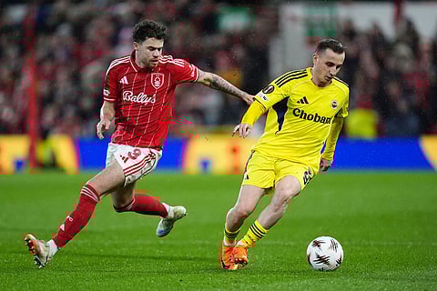Nottingham Forest's Neco Williams, left, and Fenerbahce's Kerem Akturkoglu in action during the Europa League knockout phase play-off second leg match between Nottingham Forest and Fenerbahce in Nottingham, England.
