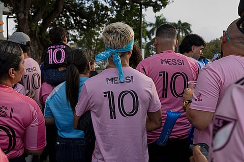 Fans wearing Inter Miami's Lionel Messi jersey are seen before the start of an international friendly soccer match against Ecuador's Independiente del Valle in Bayamon, Puerto Rico.