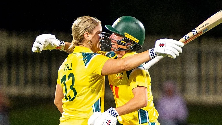 Australia cricketer Georgia Voll celebrating her century with teammates during India Women vs Australia Women. - cricketcomau/X