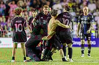 | Photo: AP/Alejandro Granadillo : A fan who got onto the field grabs Inter Miami's Lionel Messi at the end of an international friendly soccer match against Ecuador's Independiente del Valle in Bayamon, Puerto Rico.