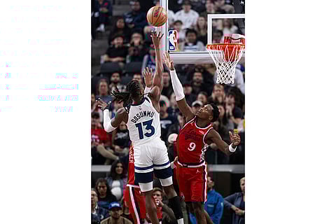 Minnesota Timberwolves guard Ayo Dosunmu (13) shoots over Los Angeles Clippers guard Bennedict Mathurin (9) during the first half of an NBA basketball game in Inglewood, Calif.