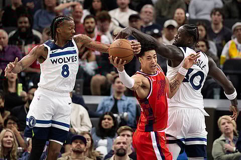 Los Angeles Clippers center Yanic Konan Niederhauser, center, vies for a rebound against Minnesota Timberwolves guard Bones Hyland, left, and forward Julius Randle during the second half of an NBA basketball game in Inglewood, Calif.