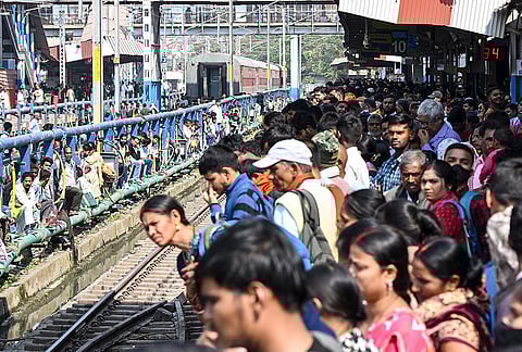 Passengers crowd a platform as they wait to board trains ahead of the 'Holi' festival, at Patna Railway Station, in Patna, Bihar.