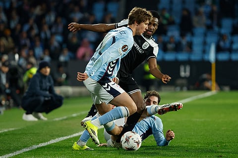 Celta's Fernando Lopez, keft, duels for the balls during the second leg of the Europa League playoff soccer match between Celta Vigo and PAOK in Vigo, Spain.