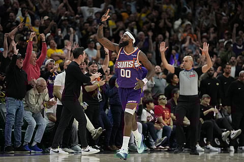 Phoenix Suns forward Royce O'Neale reacts after hitting the winning shot against the Los Angeles Lakers during the second half of an NBA basketball game in Phoenix.