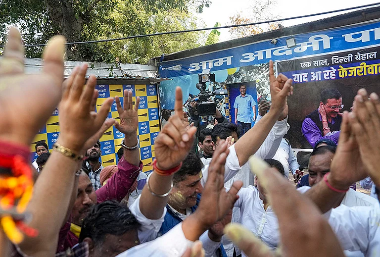 AAP members celebrate after the party's national convener Arvind Kejriwal and party leader Manish Sisodia were discharged by a Delhi court in a liquor policy case, in New Delhi. - | Photo: PTI/Karma Bhutia
