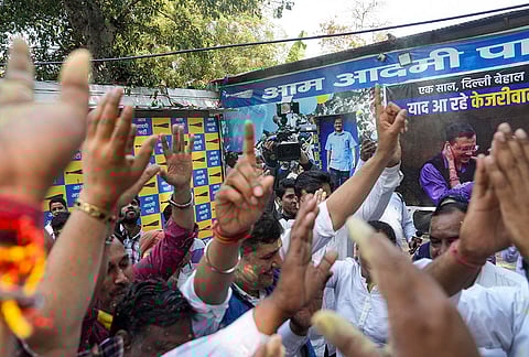 AAP members celebrate after the party's national convener Arvind Kejriwal and party leader Manish Sisodia were discharged by a Delhi court in a liquor policy case, in New Delhi.