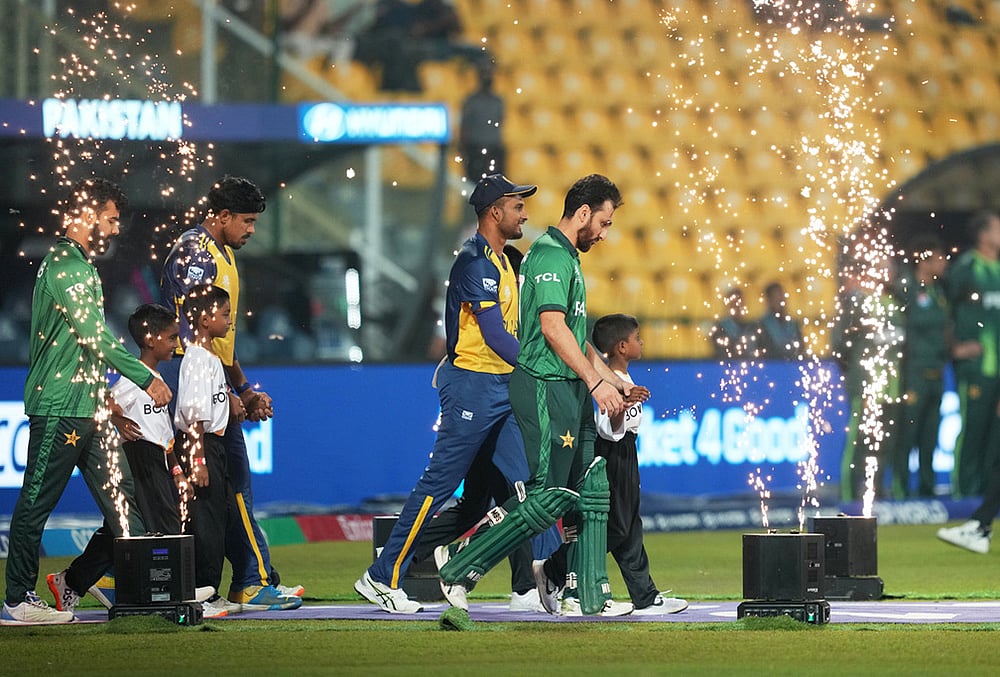 Pakistan's captain Salman Ali Agha, right, and Sri Lanka's captain Dasun Shanaka step onto the field with teammates before the start of the T20 World Cup cricket match between Pakistan and Sri Lanka in Pallekele, Sri Lanka. - | Photo: AP/Eranga Jayawardena