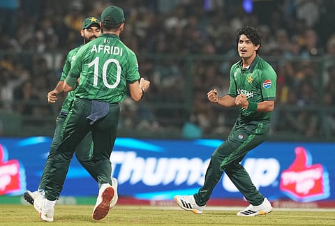Pakistan's Naseem Shah, right, celebrates with teammates the wicket of Sri Lanka's Pathum Nissanka during the T20 World Cup cricket match between Pakistan and Sri Lanka in Pallekele, Sri Lanka.