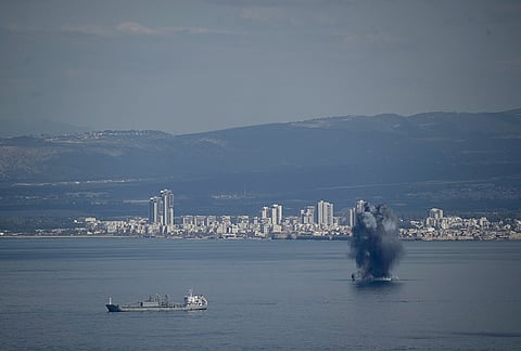 An incoming projectile explodes over the water as Israel issues a nationwide alert following its strikes on Iran, in Haifa Bay, northern Israel.
