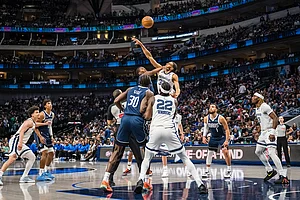 | Photo: AP/Jessica Tobias : Memphis Grizzlies guard Rayan Rupert, top center right, and Dallas Mavericks guard Miles Kelly, top center left, compete for a jump ball during an NBA basketball game in Dallas.