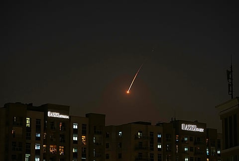 The flare of a projectile is seen over the skyline of Dubai, United Arab Emirates.