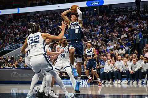 Dallas Mavericks guard Max Christie (00) looks to pass the ball during an NBA basketball game against the Memphis Grizzlies in Dallas.