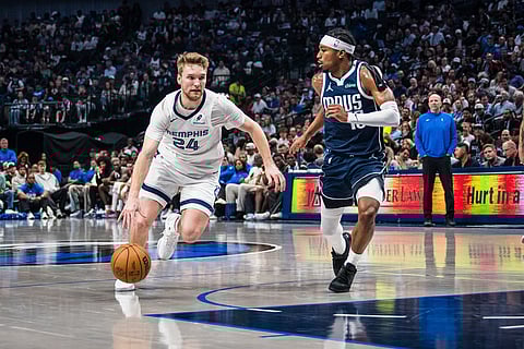 Memphis Grizzlies guard Cam Spencer (24) drives the ball during an NBA basketball game against the Dallas Mavericks in Dallas.