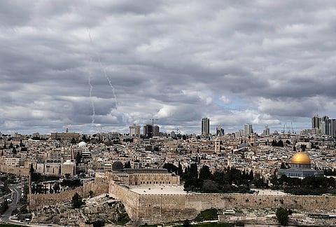 Traces of an air defense missile interception are seen, left, over Jerusalem's Old City.