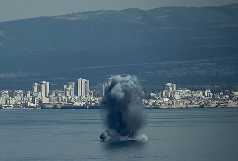 An incoming projectile explodes over the water as Israel issues a nationwide alert following its strikes on Iran, in Haifa Bay, northern Israel.