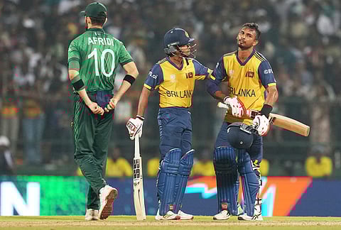 Sri Lanka's captain Dasun Shanaka, right, is consoled by teammate Dunith Wellalage after losing the T20 World Cup cricket match against Pakistan in Pallekele, Sri Lanka.