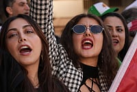 | Photo: AP/Hiro Komae : Iranians living in Japan and their families gather near the Iranian Embassy in Tokyo to show support Saturday's U.S.-Israel strikes on Iran. 