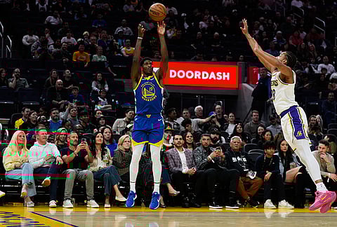 Golden State Warriors guard Nate Williams (19) shoots a 3-point basket in front of Los Angeles Lakers guard Kobe Bufkin (18) during the second half of an NBA basketball game, in San Francisco.