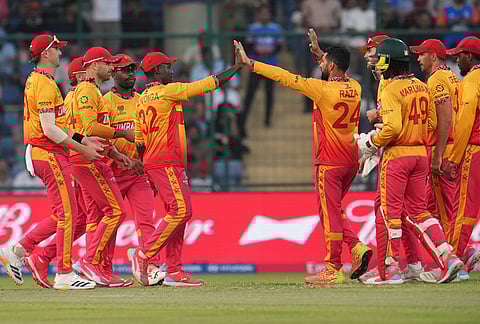 Zimbabwe's captain Sikandar Raza, centre, celebrates with teammates the wicket of South Africa's Dewald Brevis during the T20 World Cup cricket match between South Africa and Zimbabwe in New Delhi.