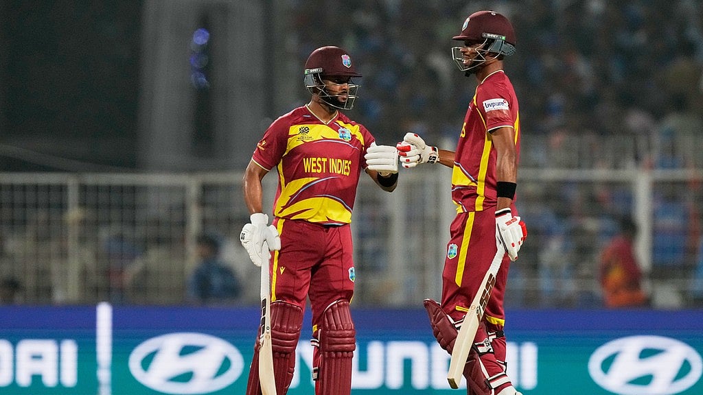 West Indies' captain Shai Hope, left, and batting partner Roston Chase touch gloves during the T20 World Cup cricket match between India and West Indies in Kolkata. - Photo: AP
