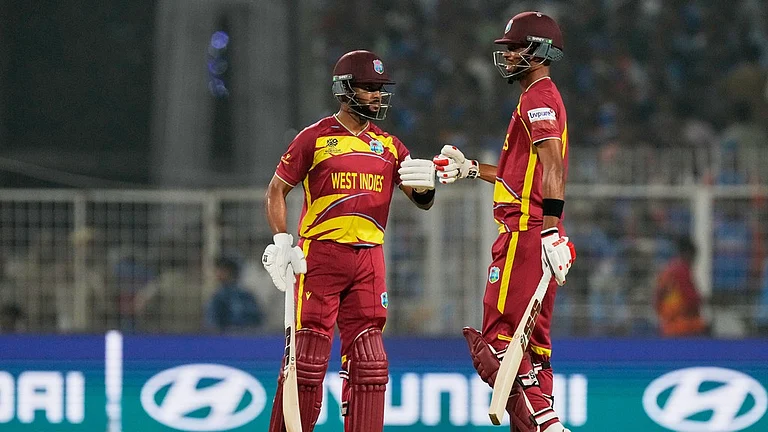 West Indies' captain Shai Hope, left, and batting partner Roston Chase touch gloves during the T20 World Cup cricket match between India and West Indies in Kolkata. - Photo: AP