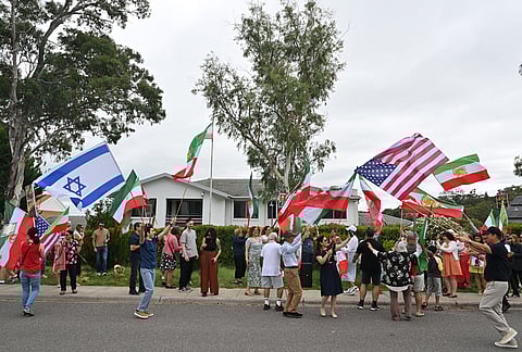 Iranian Australians react outside Iran's embassy in Canberra, Australia.